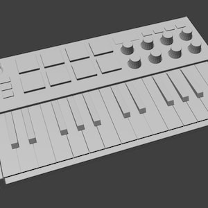 May include: A gray MIDI keyboard controller with a series of keys, knobs, and pads. The keyboard has a rectangular shape and is designed for music production and performance. The keys are arranged in a standard piano layout.