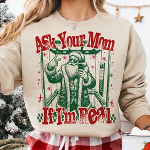 Sweat-shirt de Noël humoristique avec le Père Noël, T-shirt « Demandez à votre mère si je suis réel », Pull-over sarcastique pour les fêtes, Cadeau de Noël irrévérencieux, Haut d'hiver humoristique
