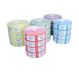 May include: Five rolls of parking tickets in various colours: yellow, green, red, purple, and blue. Each ticket is printed with "BLACK ROCK BEACH CAR PARK DAY".