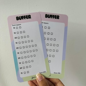 May include: Two rectangular cards with rounded corners. The cards have a white background with a pink and green border. The word "BUFFER" is at the top. Each card has a series of boxes and numbers. One card says "Save 600" and the other says "Save 200".