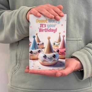 May include: A birthday card with a colorful donut design. The card says "Donut Worry It's your Birthday!" and features donuts with party hats and smiling faces.