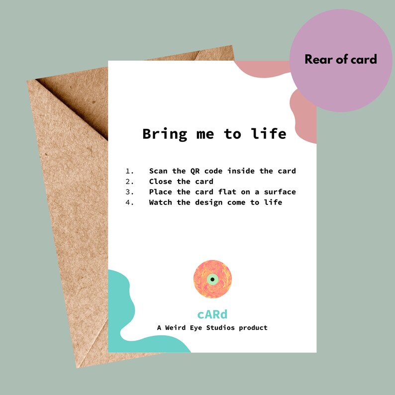 May include: A white card with instructions on how to bring the card to life. The instructions include scanning a QR code, closing the card, placing it flat on a surface, and watching the design come to life. The card has a colorful eye design and the text "CARd" and "A Weird Eye Studios product".