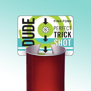 May include: A red plastic cup with a green and white sign that says "DUDE" and "PING PONG PERFECT TRICK SHOT".