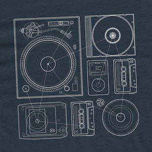 May include: A navy blue graphic tee featuring a white blueprint design of various music playback devices. The design includes a record player, CD, iPod, cassette tapes, and a radio.