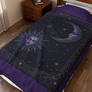 May include: A dark purple and black bedspread featuring a central sun face with radiating rays and a crescent moon face. The design includes a starry night sky background with constellations and an ornate, decorative border with swirling patterns.