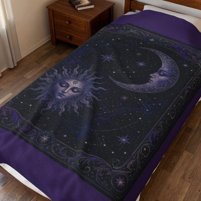 May include: A dark purple and black bedspread featuring a central sun face with radiating rays and a crescent moon face. The design includes a starry night sky background with constellations and an ornate, decorative border with swirling patterns.