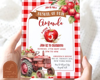 May include: A rectangular birthday invitation card featuring a red and white gingham border, a red tractor, and red apples. The text reads: JOIN US FOR A BUSHEL OF FUN, Amanda is turning 5, JOIN US TO CELEBRATE! SUNDAY, 17TH SEPT 20XX, 2PM TO 4PM.