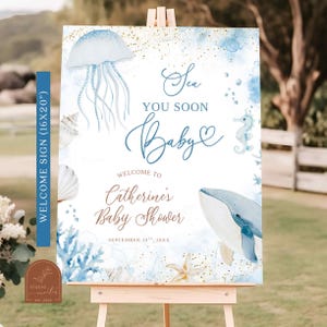 May include: A welcome sign for a baby shower, featuring a watercolor design with a sea theme. The sign includes a jellyfish, whale, seahorse, and seashells in shades of blue and gold. Text reads "Sea You Soon Baby" and welcomes guests to Catherine's Baby Shower.