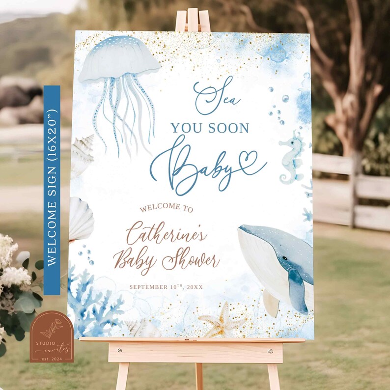 May include: A welcome sign for a baby shower, featuring a watercolor design with a sea theme. The sign includes a jellyfish, whale, seahorse, and seashells in shades of blue and gold. Text reads "Sea You Soon Baby" and welcomes guests to Catherine's Baby Shower.