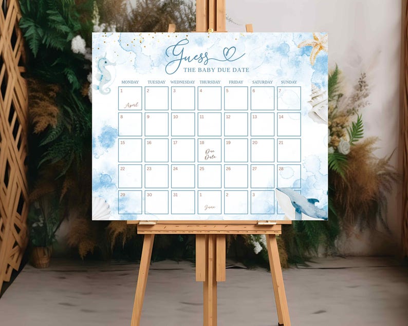 May include: A baby shower calendar sign on a wooden easel. The sign features a blue watercolor background with seahorse and whale illustrations. The text reads "Guess the Baby Due Date" with a calendar grid for guests to write their guesses.