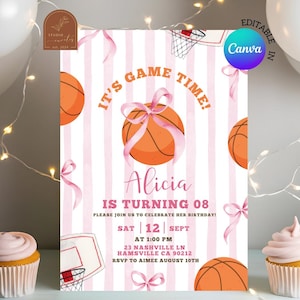 May include: A birthday invitation card featuring a white and pink striped background with orange basketballs tied with pink ribbons. The text reads IT'S GAME TIME! ALICIA IS TURNING 08. PLEASE JOIN US TO CELEBRATE HER BIRTHDAY! SAT 12 SEPT AT 1:00 PM.