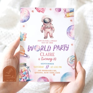 May include: A pink and purple invitation with a watercolor design featuring an astronaut, planets, stars, and candy. The text reads "Join us for a sweet out of this world party Claire is turning 10 September 17 at 4:00 PM 135 Prohaska Rd, Queens, New York 2325".