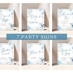 May include: Set of seven baby shower party signs with a watercolor ocean theme. Each sign features a blue and white design with jellyfish, whales, and coral. Text includes "Diaper Raffle", "Cards & Gifts", and "Books for Baby".