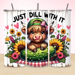 May include: A set of three stainless steel tumblers with a whimsical design. The design features a cartoon Highland cow wearing a green cap and holding a pickle, with the text "JUST DILL WITH IT". The tumblers are decorated with sunflowers and hearts.