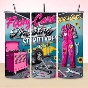 May include: A pink tumbler with a design featuring a pink toolbox, a car, and a pink jumpsuit. The text reads "Fixing Cars Breaking Stereotypes" and "Grease & Grace". The design includes sunflowers and tools.