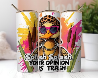 May include: A white tumbler with a colorful design featuring a cartoon duck wearing sunglasses and a bandana. The text "Splish Splash. Your Opinion Is Trash" is printed on the tumbler.