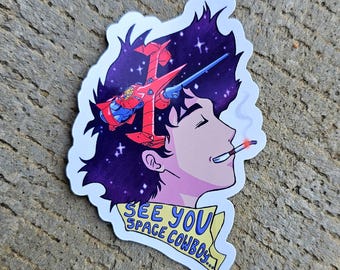 May include: A sticker featuring a cartoon illustration of a man with a spaceship in his hair. The man is smiling and holding a cigarette. The sticker has the text "See You Space Cowboy..." in yellow.