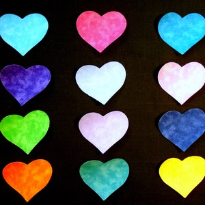 May include: Twelve heart-shaped paper cutouts in various colors, including blue, pink, light blue, purple, green, lavender, dark blue, yellow, and orange, arranged in three rows of four on a black background.