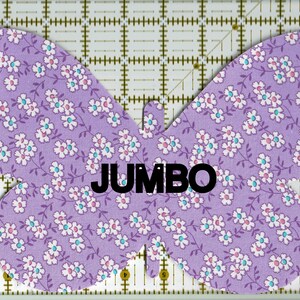 May include: Purple fabric butterfly with a white and light blue floral pattern. The word "JUMBO" is printed in black on the butterfly.