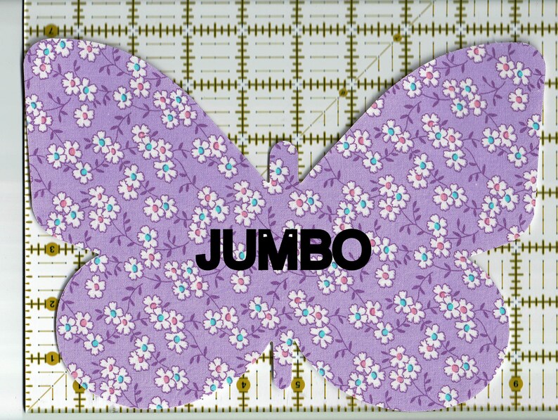 May include: Purple fabric butterfly with a white and light blue floral pattern. The word "JUMBO" is printed in black on the butterfly.