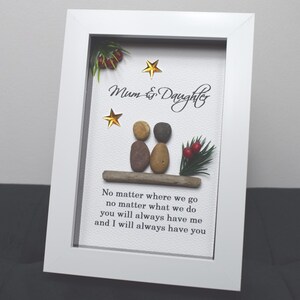 May include: White framed picture with a pebble art design of two figures, a quote that reads "Mum & Daughter No matter where we go no matter what we do you will always have me and I will always have you", and gold stars.