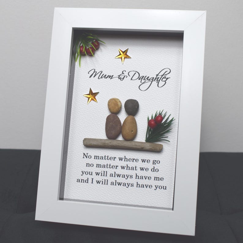 May include: White framed picture with a pebble art design of two figures, a quote that reads "Mum & Daughter No matter where we go no matter what we do you will always have me and I will always have you", and gold stars.