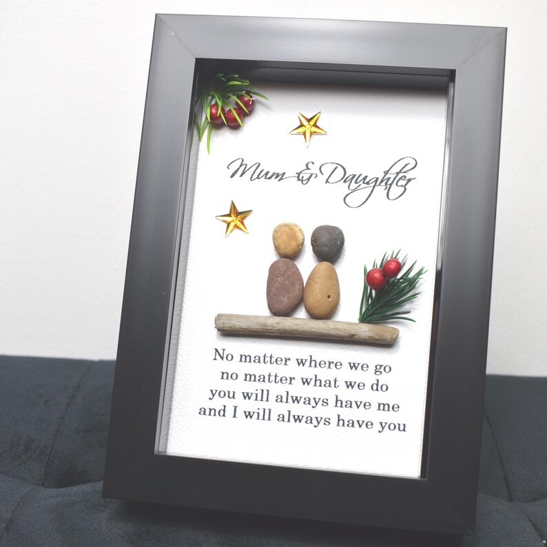 May include: A framed artwork featuring a pebble art design of two figures, representing a mother and daughter, with the text "Mum & Daughter" and a quote: "No matter where we go no matter what we do you will always have me and I will always have you".
