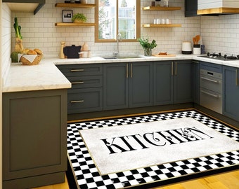 May include: A black and white checkered kitchen rug with a white background and the word "Kitchen" in black lettering.