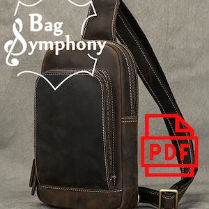 May include: A brown leather crossbody bag with a zippered pocket on the front and a large zippered compartment. The bag has a long adjustable strap and a metal buckle. The bag is made by Bag Symphony.