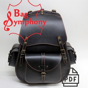 Peut inclure: Sac à dos en cuir noir avec deux poches latérales et une grande poche avant. Le sac à dos est doté d'une garniture en cuir marron et de boucles en laiton. Le texte "Bag Symphony" est visible sur le dessus du sac à dos.
