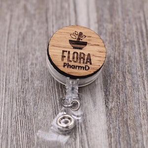 May include: A white ceramic mug with a black handle and the text "But First, Coffee" in a black, handwritten-style font. The mug is on a white surface.