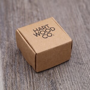 May include: A small, brown cardboard box with the text "HART WOOD CO." printed on the top.