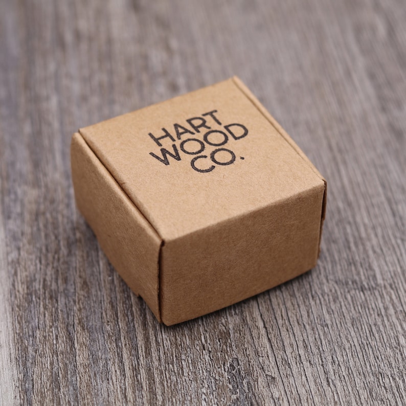 May include: A small, brown cardboard box with the text "HART WOOD CO." printed on the top.