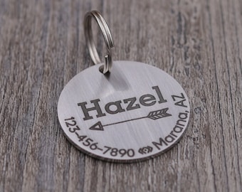 May include: Silver dog tag with an arrow design, the name "Hazel", a phone number, and the location "Marana, AZ".