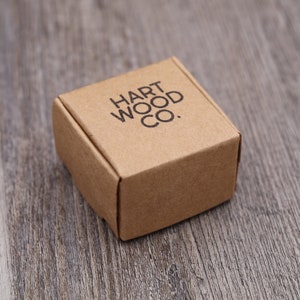 May include: A small, brown cardboard box with the text "HART WOOD CO." printed on the top.