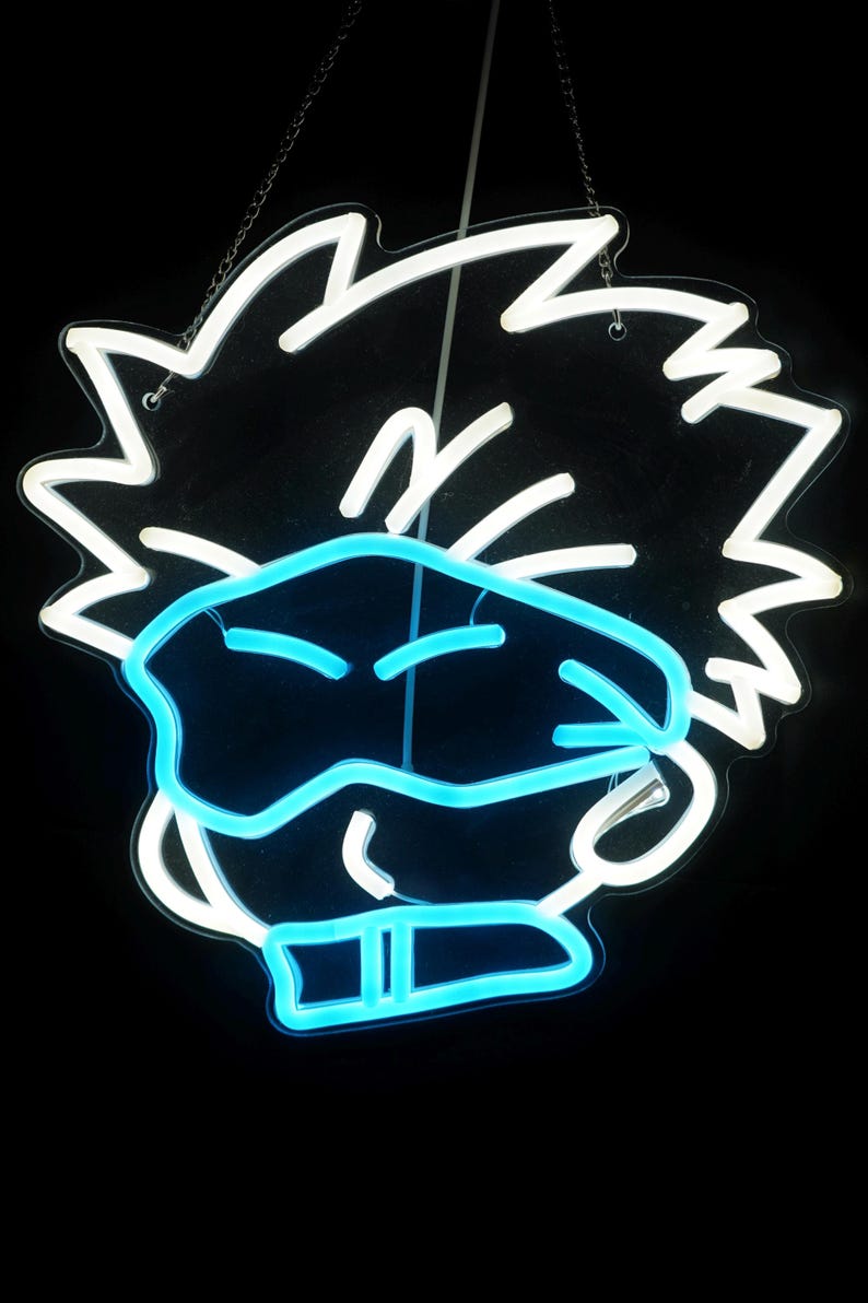 May include: A neon sign depicting a cartoon character with spiky hair wearing a blue eye mask. The sign is white with blue neon accents.
