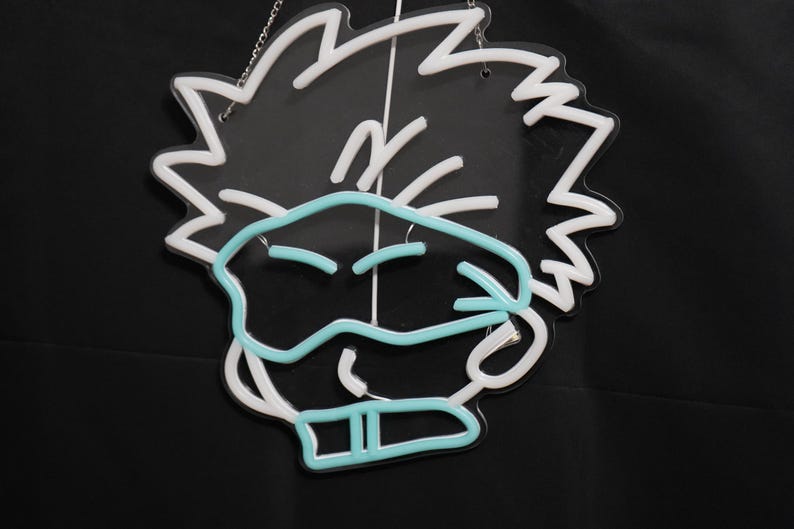 May include: White neon sign with a cartoon character wearing a blue mask. The character has spiky hair and a mischievous expression.