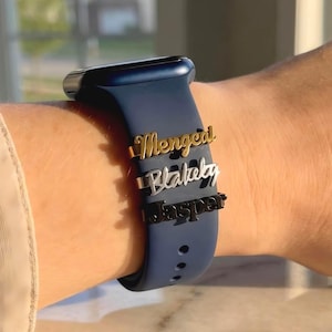 May include: A white ceramic mug with a black handle and the text "But First, Coffee" in a handwritten style. The mug is on a white surface. The mug is approximately 4 inches tall.