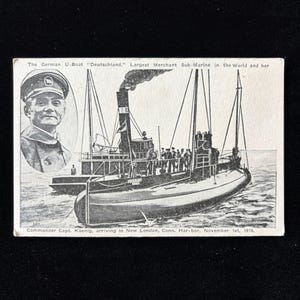 Könnte beinhalten: Schwarz-Weiß-Postkarte aus der Zeit, die das deutsche U-Boot "Deutschland" zeigt, das größte Handelsschiff-U-Boot der Welt. Die Karte zeigt eine Illustration des U-Boots und ein Porträt von Kommandant Capt. Koenig. Text: "arriving in New London, Conn. Har-bor, November 1st, 1916."