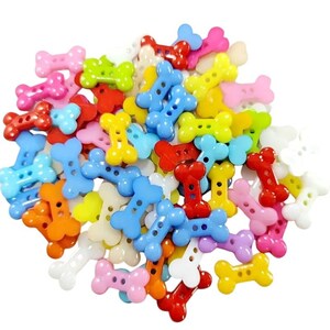 May include: A collection of colorful bone-shaped buttons in various shades, including pink, red, blue, yellow, and green. Each button has two or four holes for sewing. These plastic buttons are ideal for craft projects and sewing.