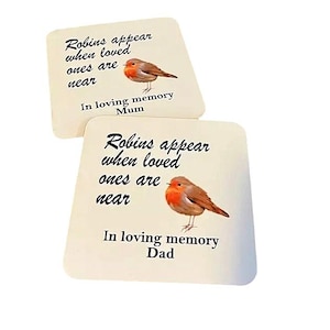 May include: Two white coasters with a robin bird illustration and the text "Robins appear when loved ones are near" with "In loving memory Mum" and "In loving memory Dad" on each coaster.