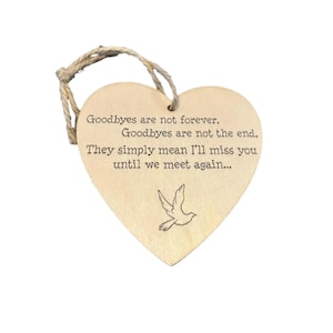 May include: A wooden heart-shaped decoration with a natural finish and a jute string. The ornament has engraved text: "Goodbyes are not forever, Goodbyes are not the end, They simply mean I'll miss you until we meet again..." and a dove illustration.