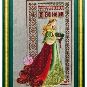 May include: Cross-stitch artwork of a woman in a long red and green dress holding a wreath with candles. The word "NOEL" is stitched above her head. The artwork is framed in a green and gold frame.
