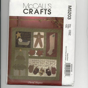 May include: A McCall's Crafts quilting pattern for a Christmas quilt. The pattern includes a gingerbread man, a stocking, a Christmas tree, and mittens. The text on the pattern reads "For unto us a Savior is born" and "Mittens mittens everywhere you can always find one but never a pair".
