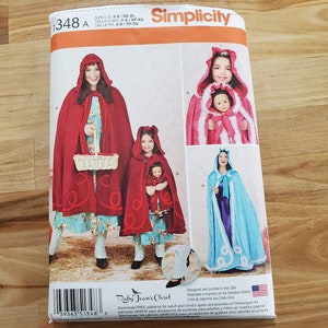 May include: Simplicity sewing pattern number 1348 A for making red and blue hooded capes with white fur trim. The pattern includes instructions for making capes for adults and children. The pattern is designed and printed in the USA.