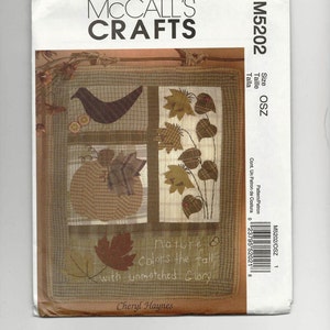 May include: A quilt pattern featuring a patchwork design with a bird, leaves, and a pumpkin. The text "nature Colors the fall with unmatched Glory" and "Cheryl Haynes" are also included.
