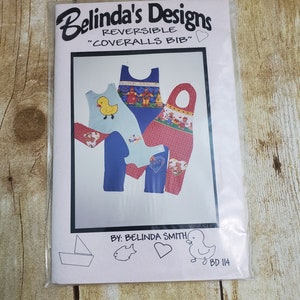 May include: A sewing pattern for a reversible "coveralls bib" for babies. The pattern includes two designs, one with a duck and the other with a bear. The pattern is by Belinda Smith and is numbered BD 114.