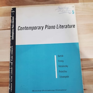 May include: A vintage copy of "Contemporary Piano Literature" book 5, featuring a white and teal cover. The book lists composers Bartók, Finney, Kabalevsky, Prokofiev, and Tcherepnin. The cover also includes the text "Frances Clark Library for Piano Students."