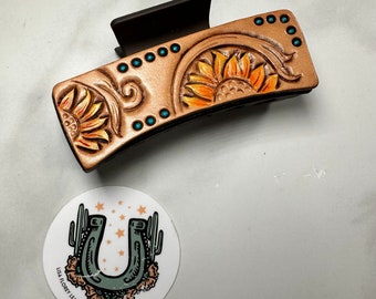 Four inch sunflower hair claw clip with genuine leather, hand tooled and hand painted flowers and turquoise accents. One of a kind accessory