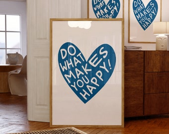 May include: Three framed art prints with a white background and a blue heart design. The heart contains the words "DO WHAT MAKES YOU HAPPY!" in white. The frames are a light brown color. The prints are displayed in a room with wooden floors.